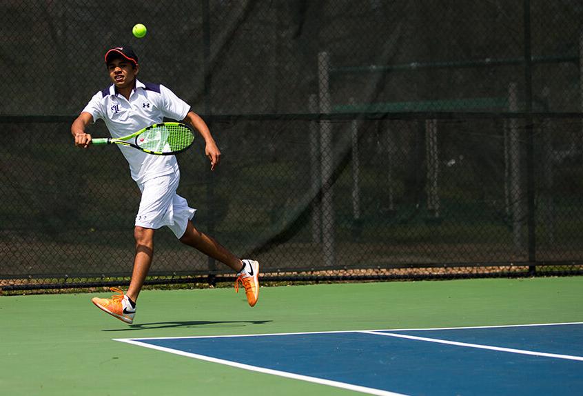 Boys Tennis player hitting the tennis ball